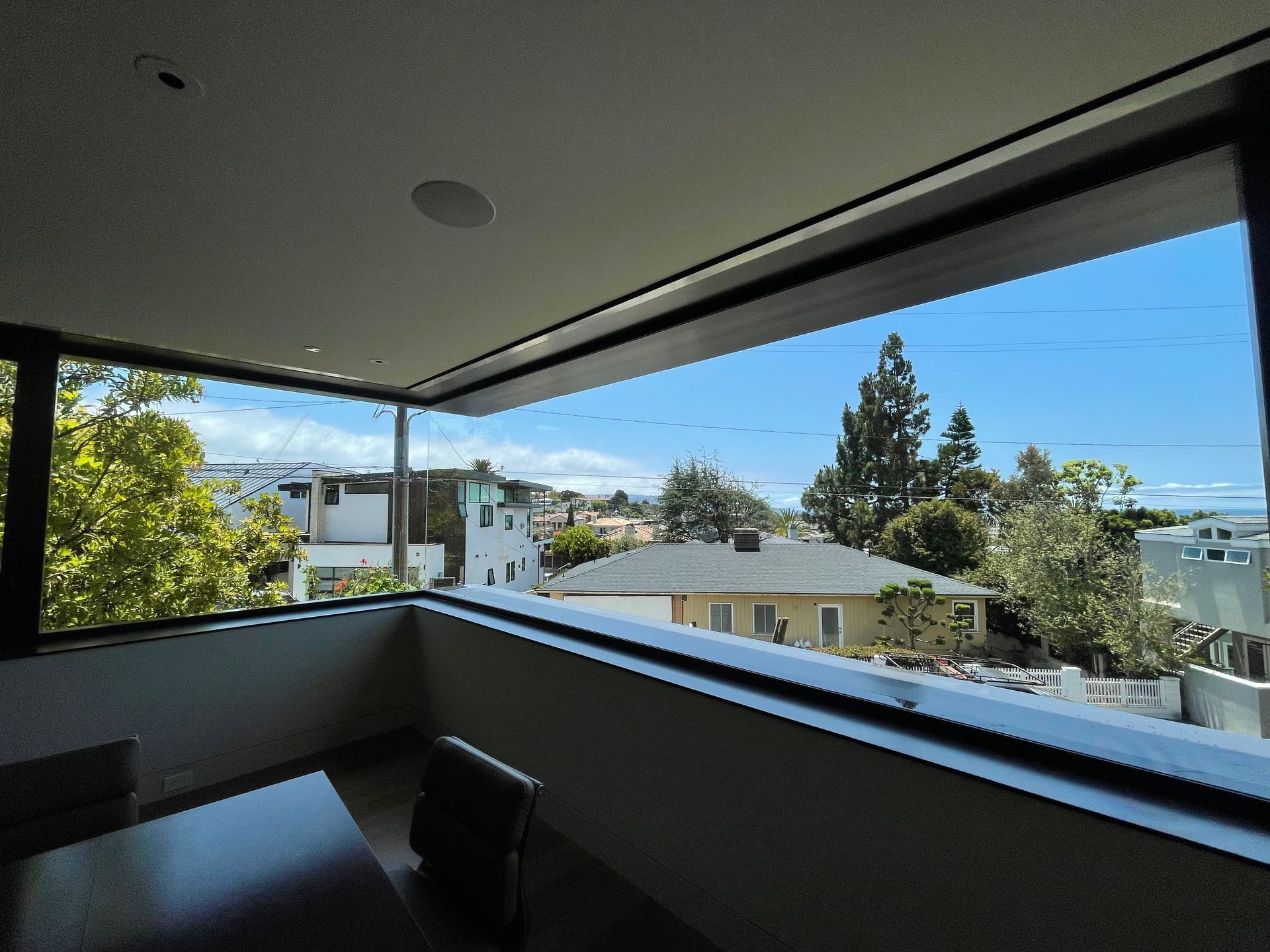 a large window with a view of houses and trees