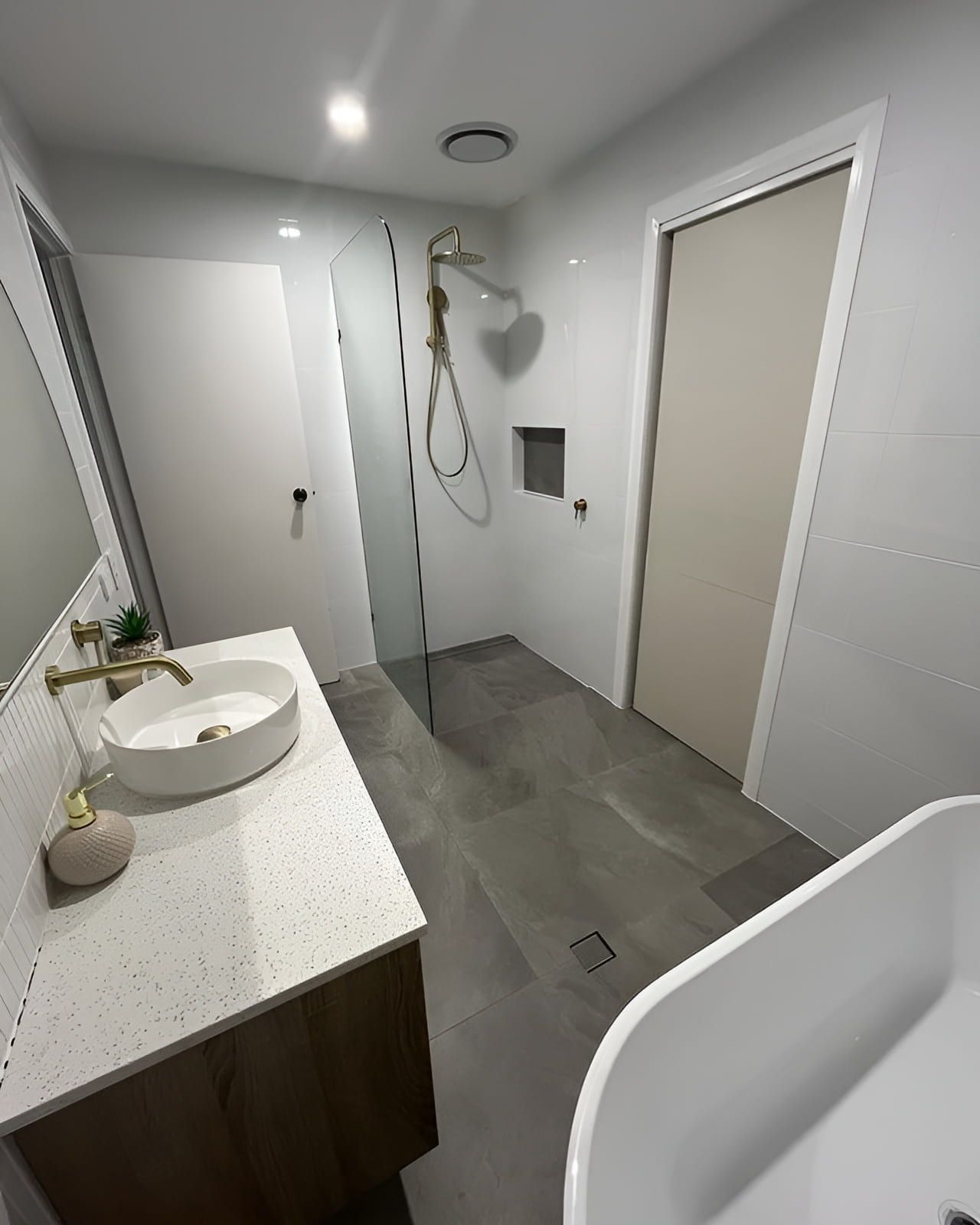 A Bathroom With A Sink And A Walk In Shower — Old Mate Plumbing Co in Labrador, QLD