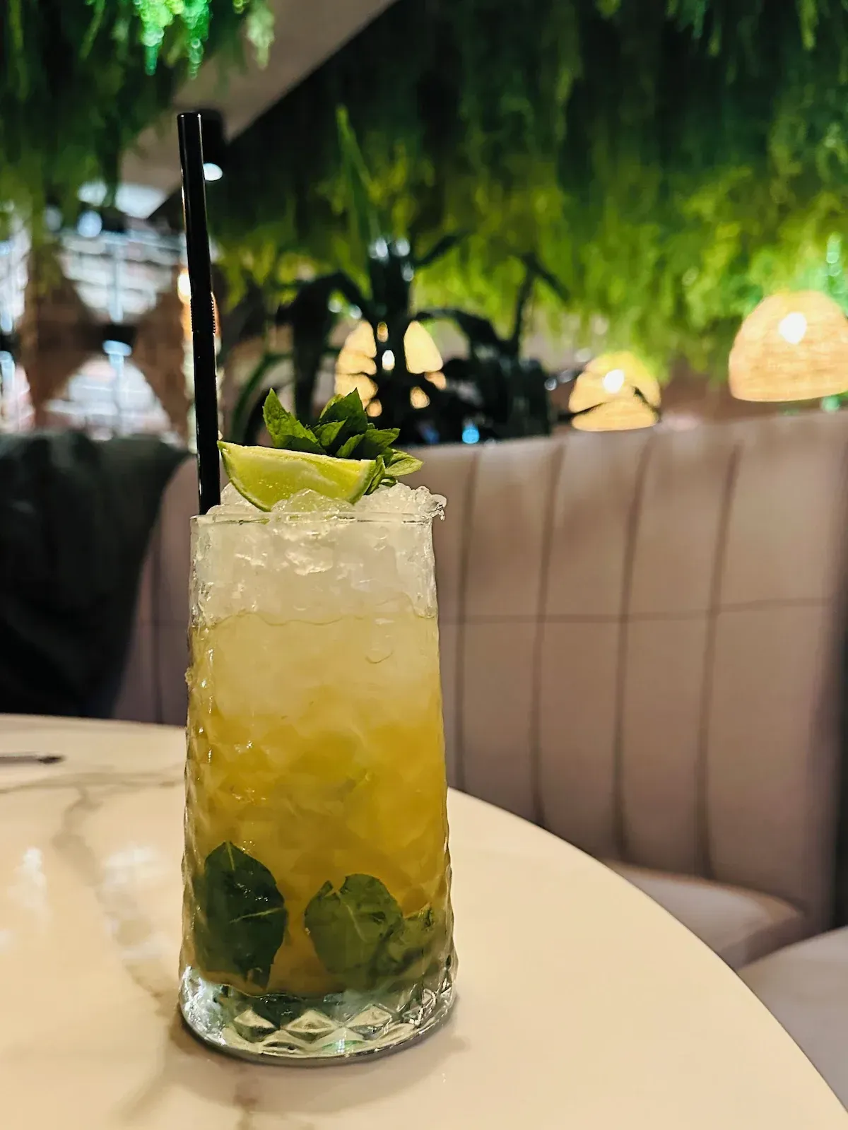 A close up of a drink with a straw on a table