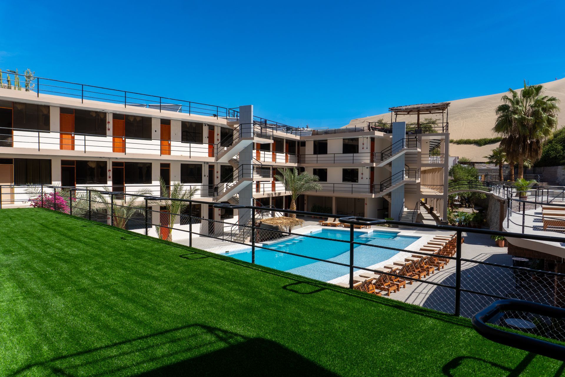 A large building with a swimming pool in front of it.