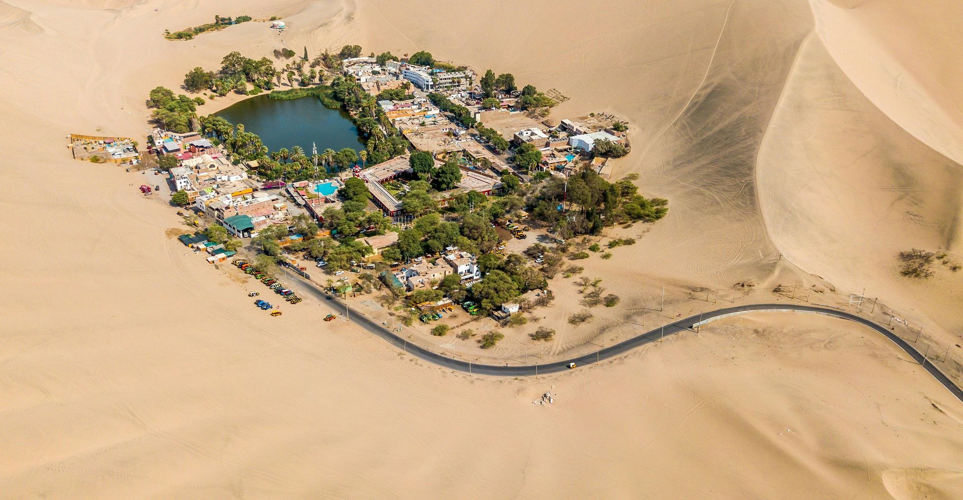 An aerial view of a small island in the middle of a desert.