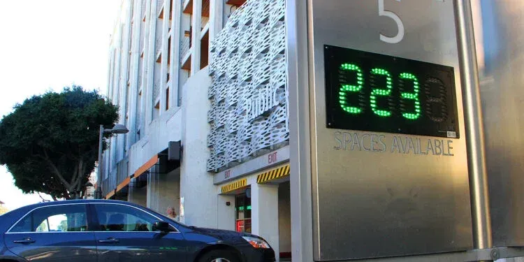 A car is parked in front of a sign that says 223