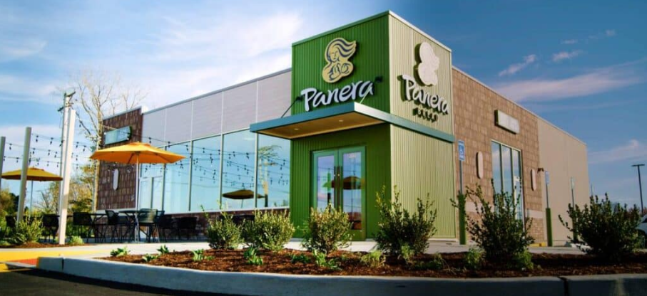 A panera restaurant with umbrellas in front of it