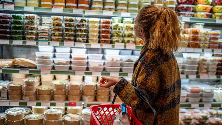 A car is parked in front of a sign that says 223