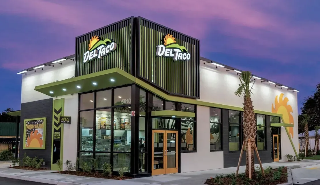 A del taco restaurant with a purple sky in the background.