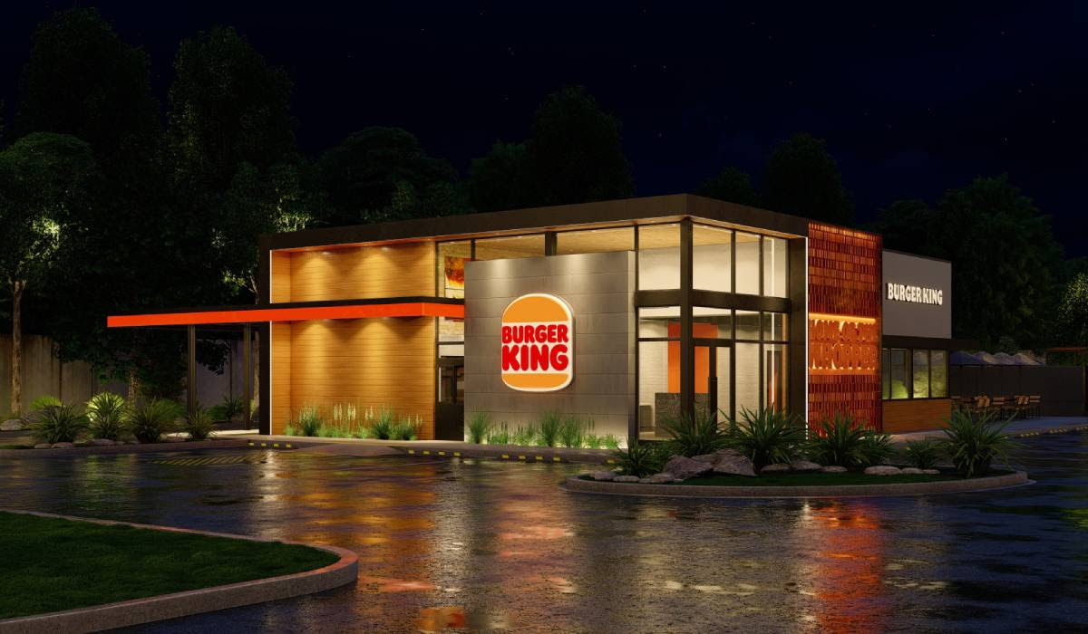An artist 's impression of a burger king restaurant at night.