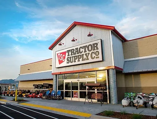 The front of a tractor supply co. store with a red roof.