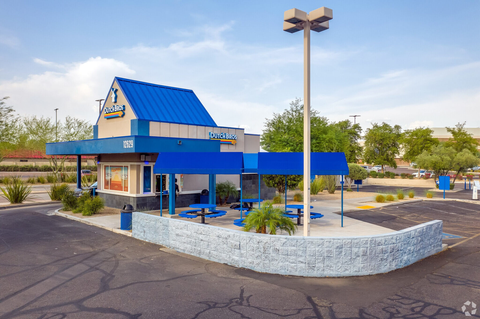 A fast food restaurant with a blue roof and blue awnings