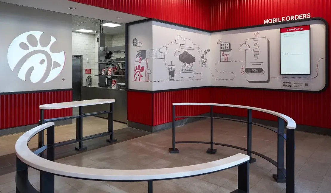A chick-fil-a restaurant with a circular table in the middle of the room.