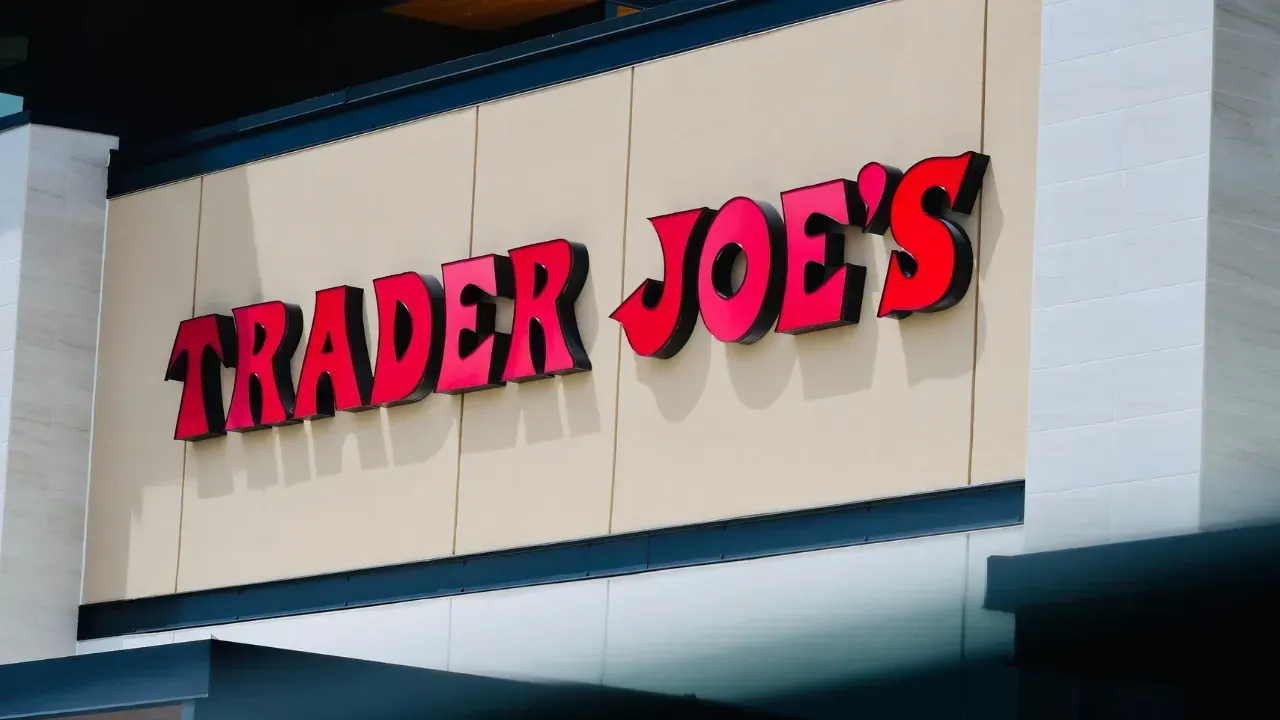 The front of an aldi store with a sign in front of it.