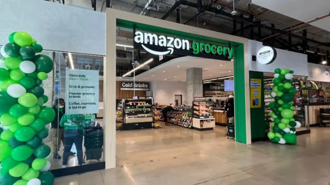 The inside of an amazon grocery store with green and white balloons.