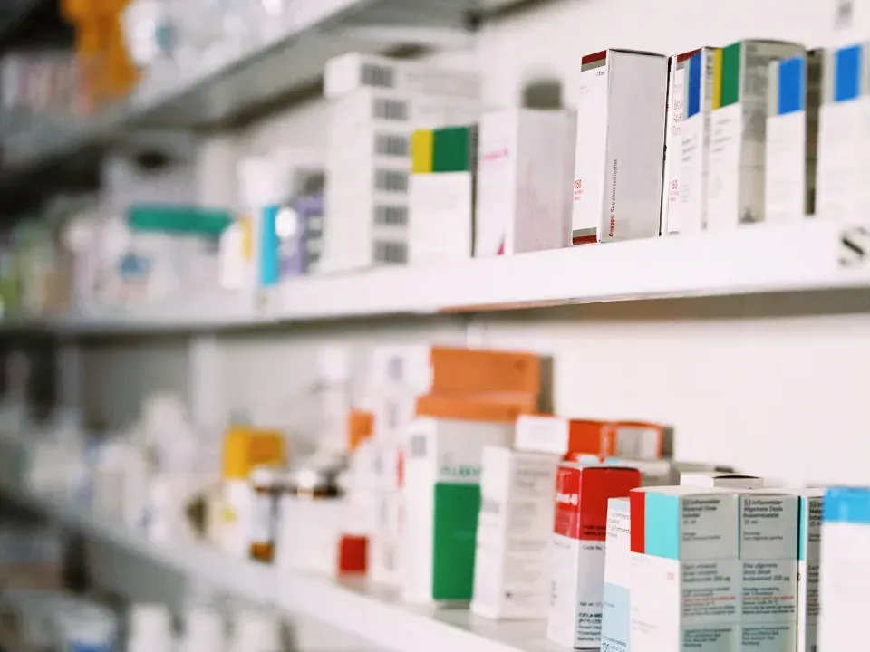 A pharmacy shelf filled with lots of different types of medications.