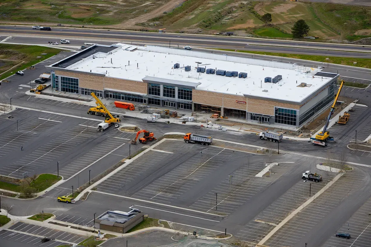 A car is parked in front of a sign that says 223