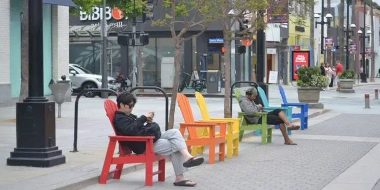 A blurred image of a city street with people walking down it.