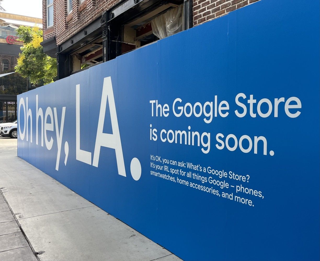 A blue sign that says the google store is coming soon