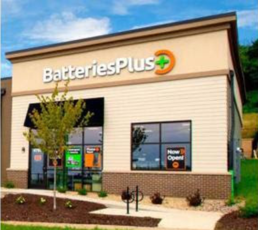 A store front for batteries plus with a sign that says now open