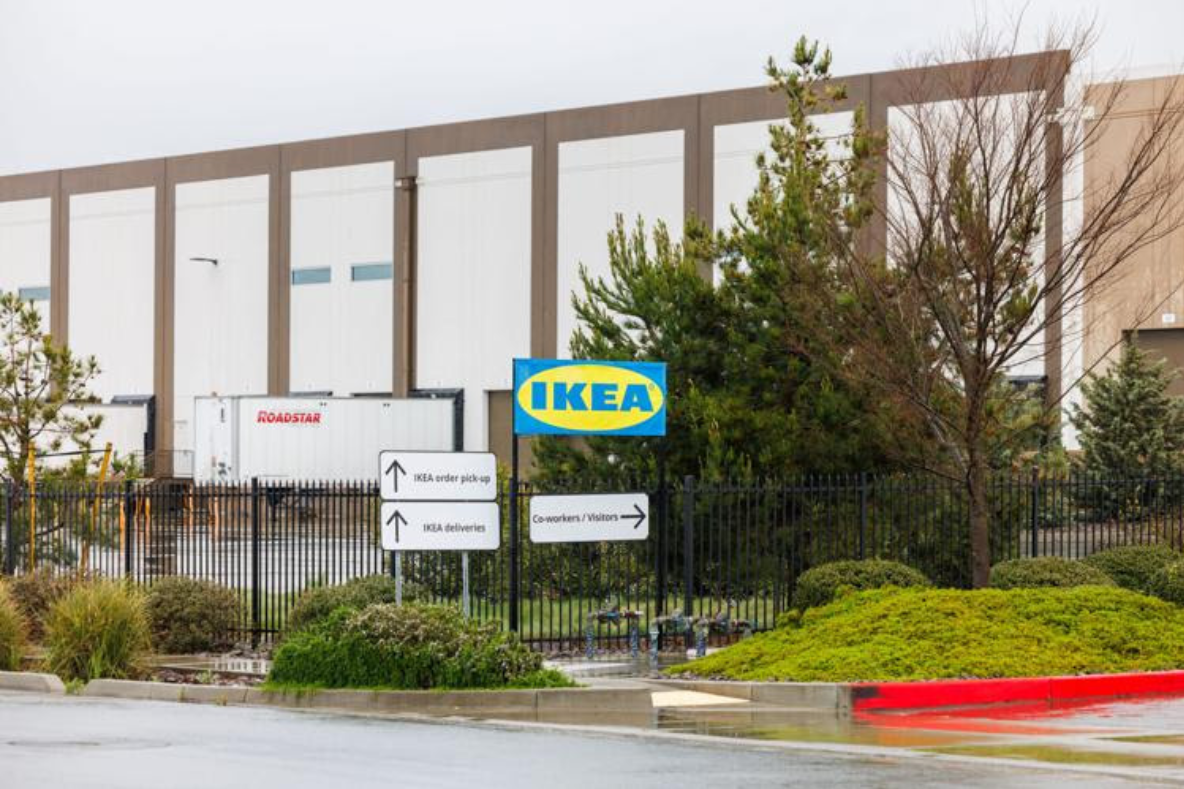 A sign for ikea is in front of a building.