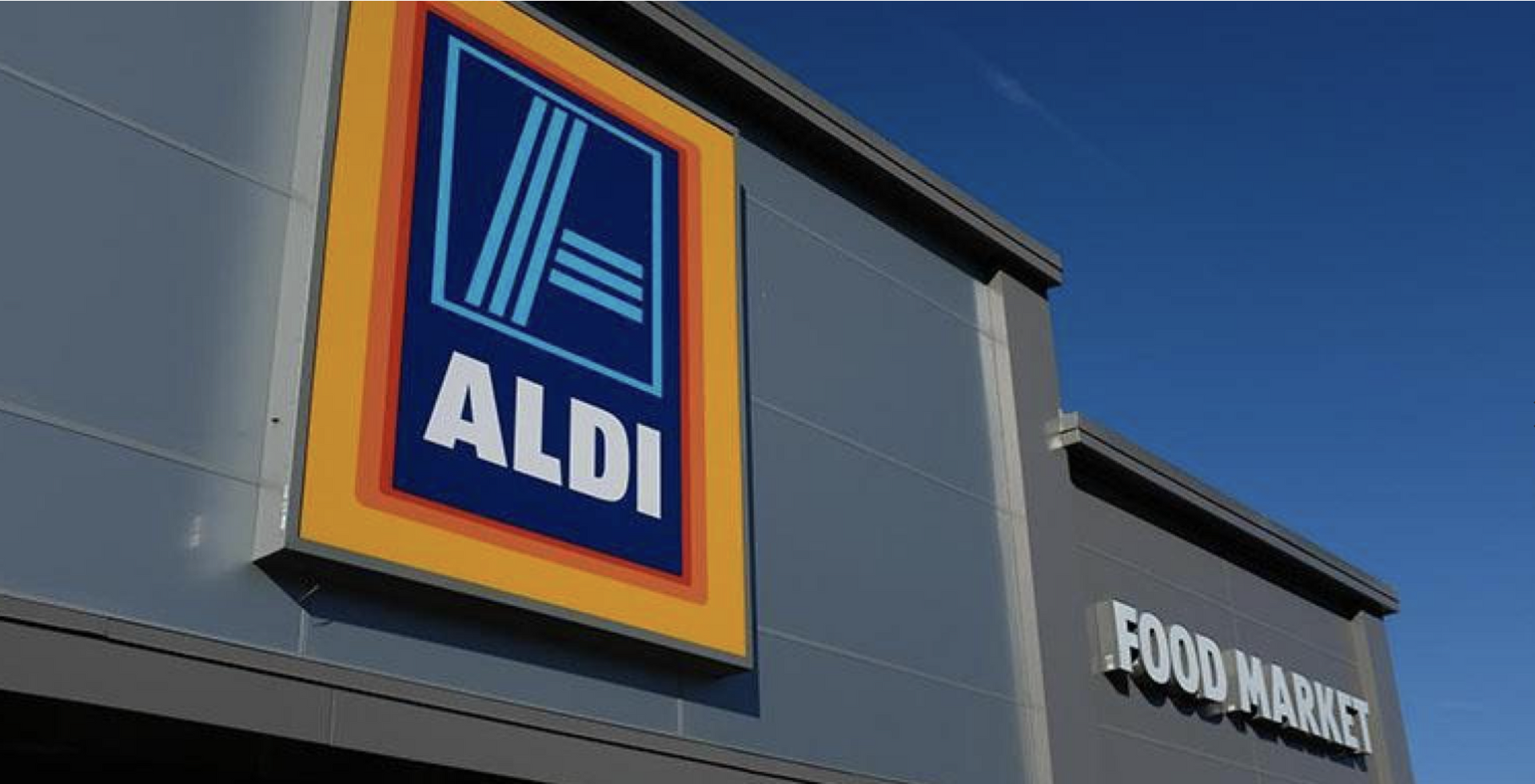 A large sign on the side of a building that says aldi food market.
