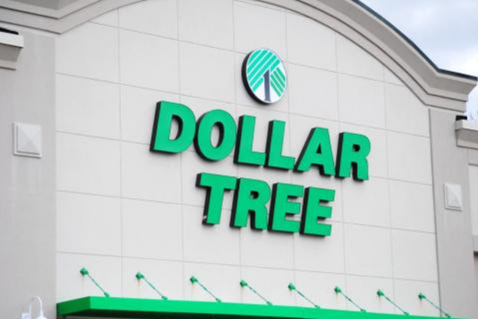 The front of a dollar tree store with a green awning