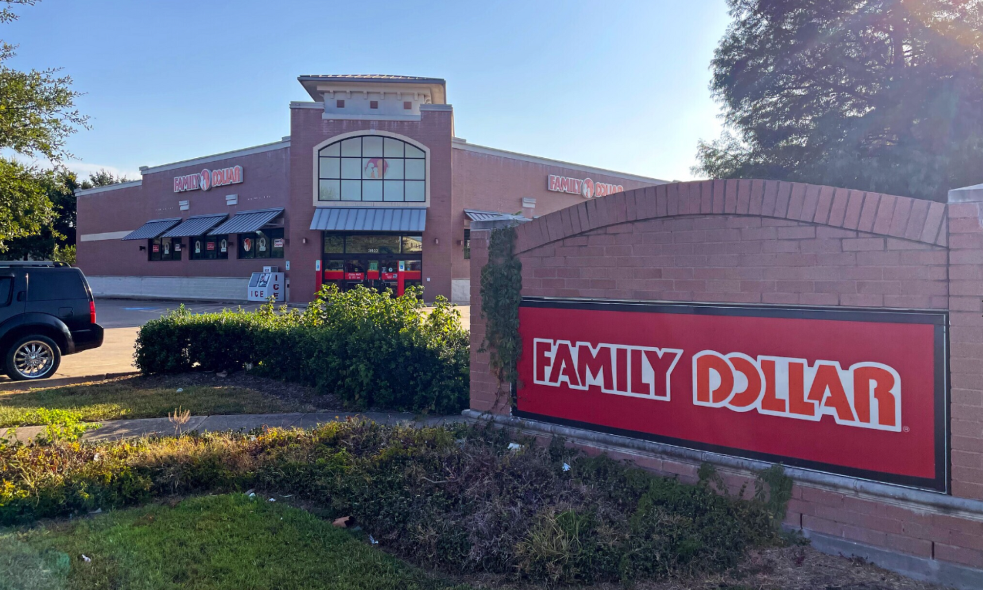 A family dollar store with a red sign in front of it.