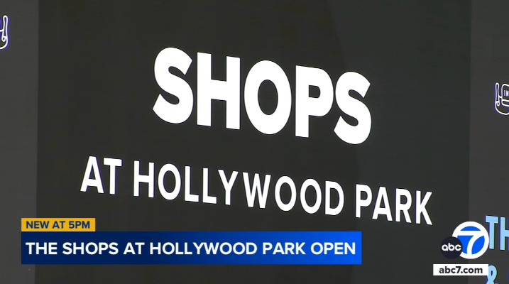A sign that says shops at hollywood park on it
