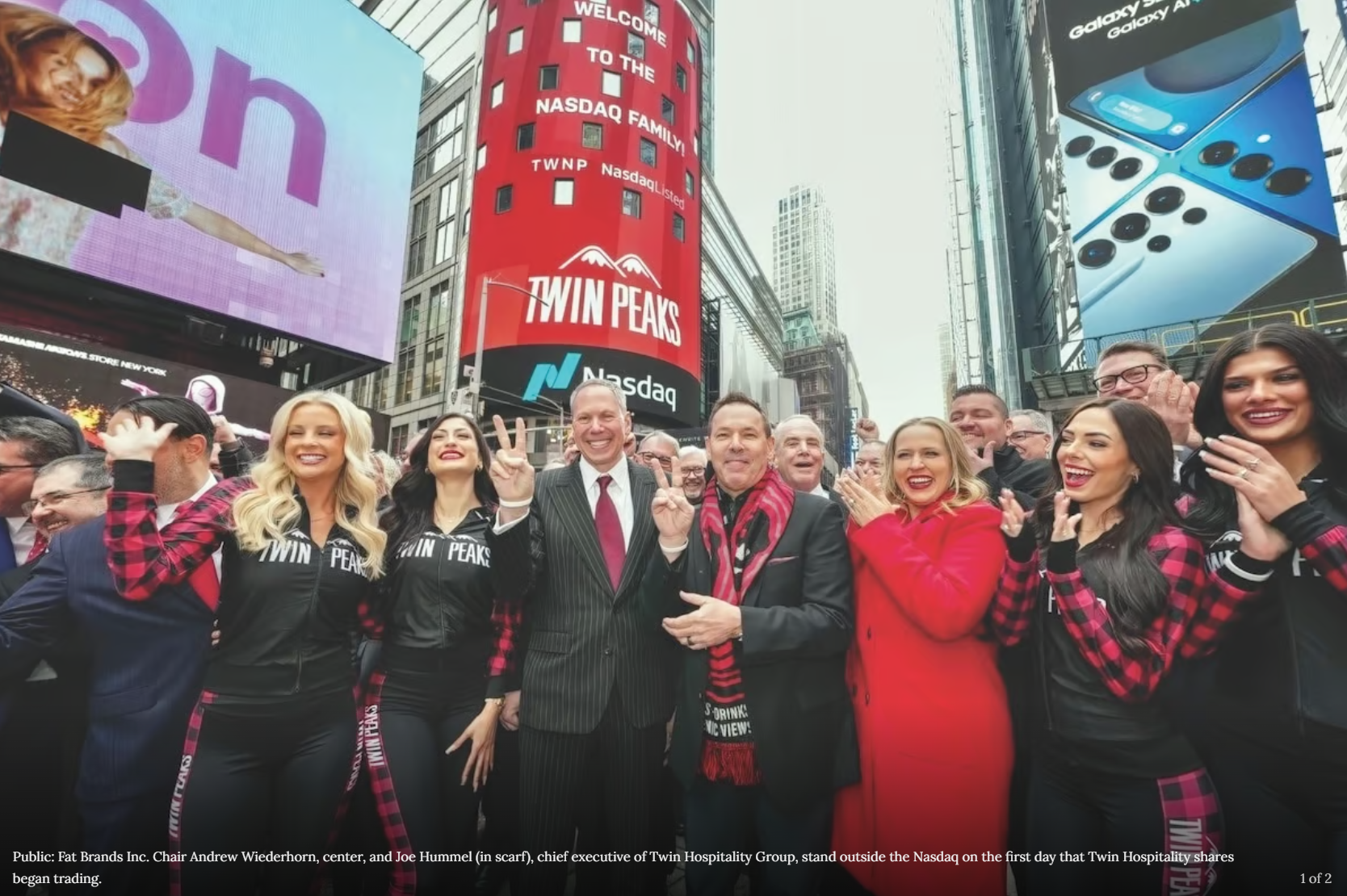 A group of people standing in front of a sign that says twin peaks
