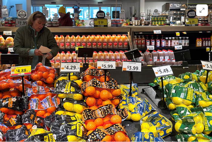 A blurred image of a city street with people walking down it.