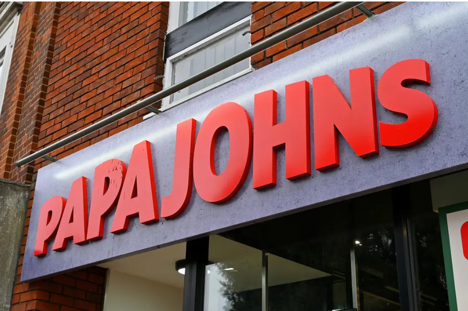 The front of an aldi store with a sign in front of it.