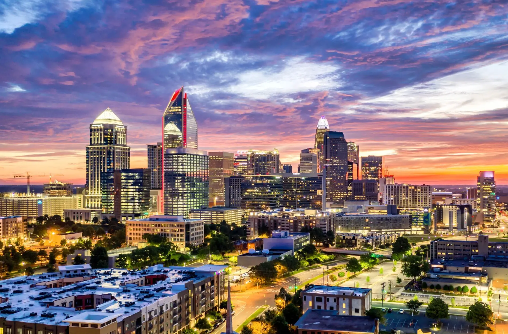 A blurred image of a city street with people walking down it.
