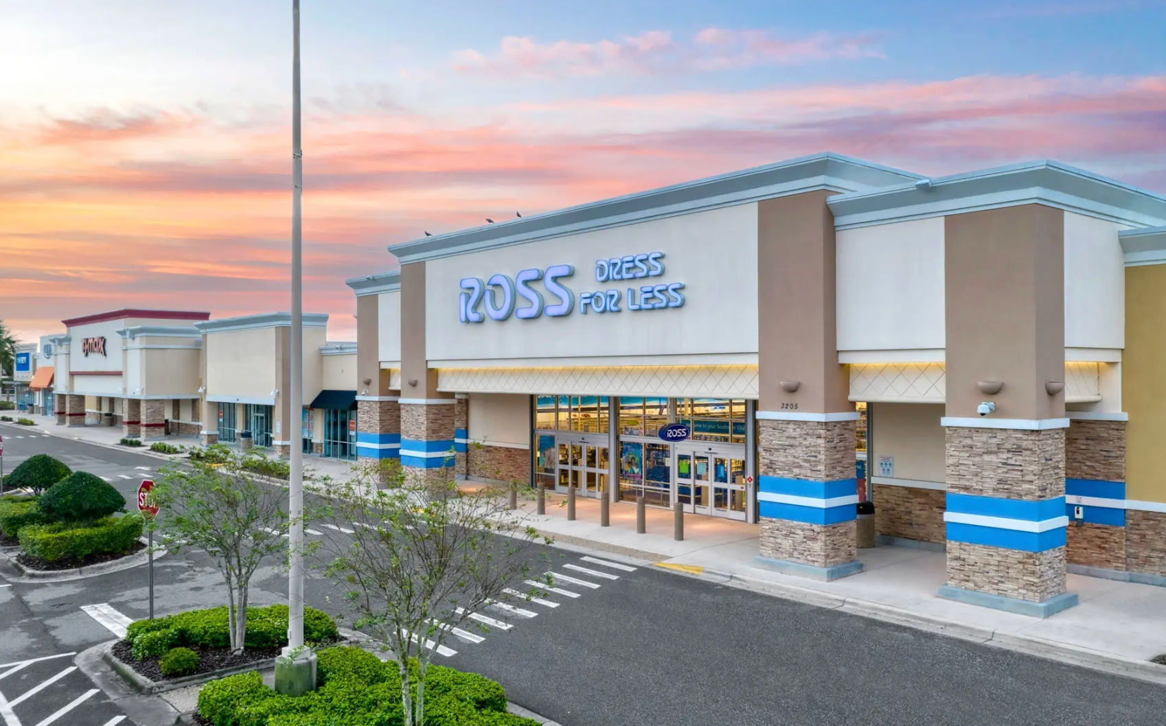 A car is parked in front of a sign that says 223