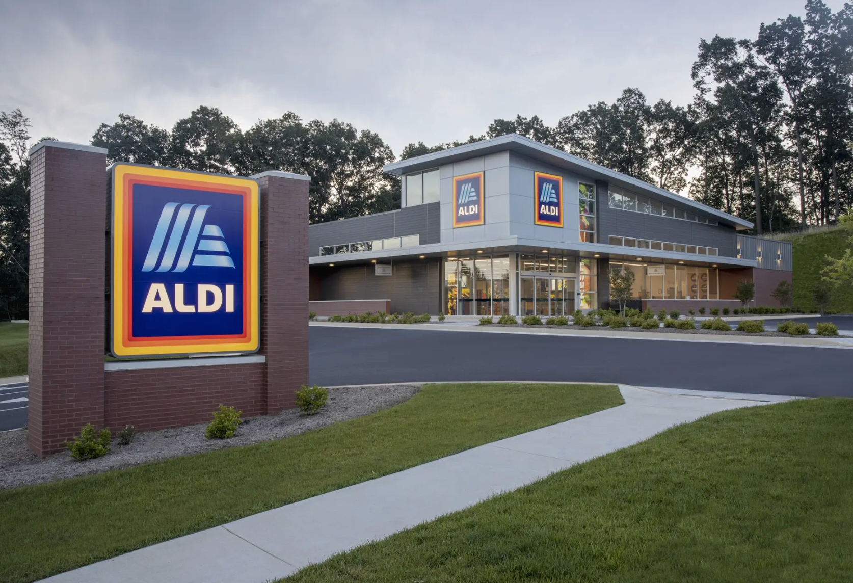 The front of an aldi store with a sign in front of it.