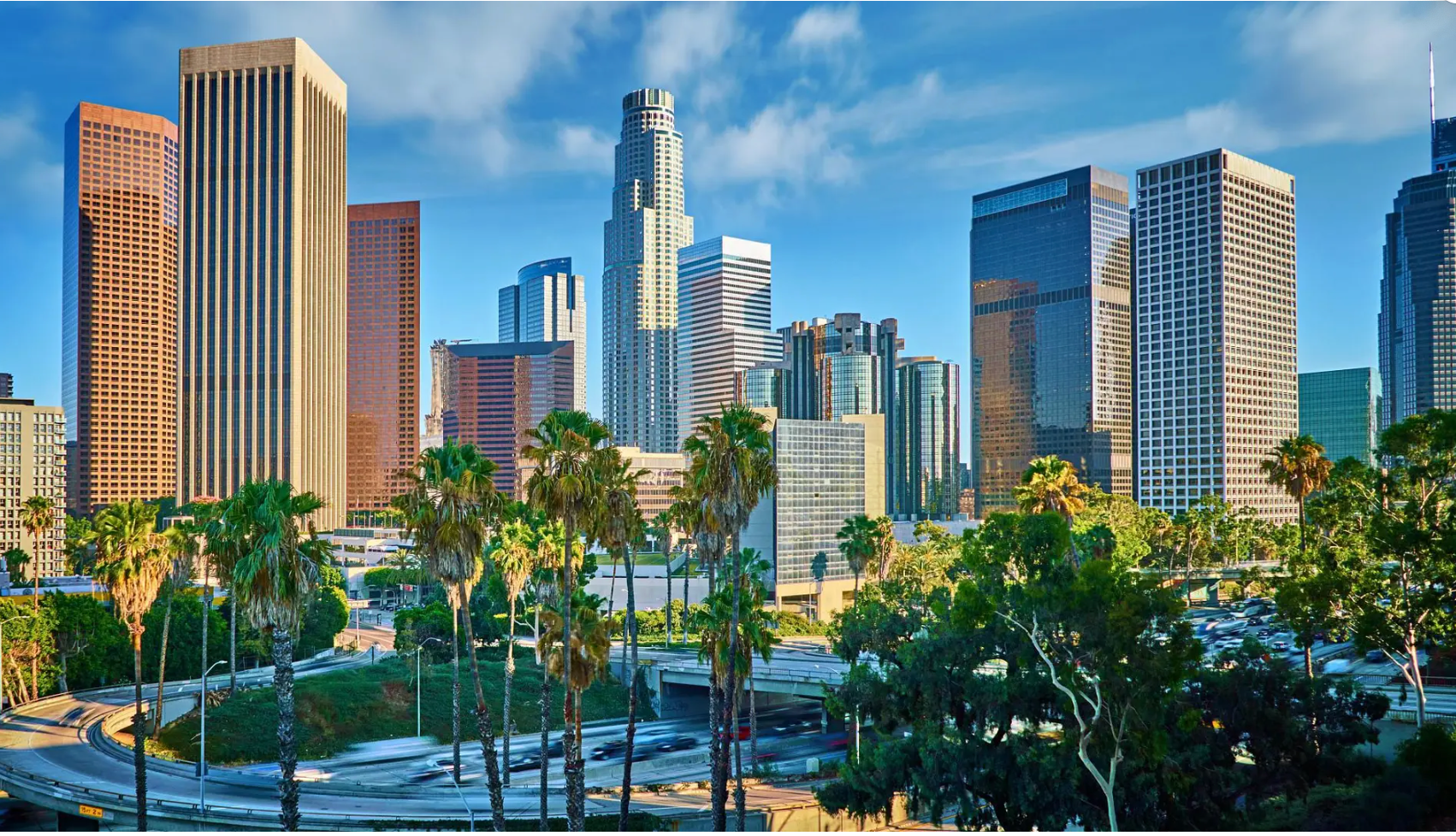 Interior of a casual restaurant featuring blue chairs, red accents, brick walls, and a 