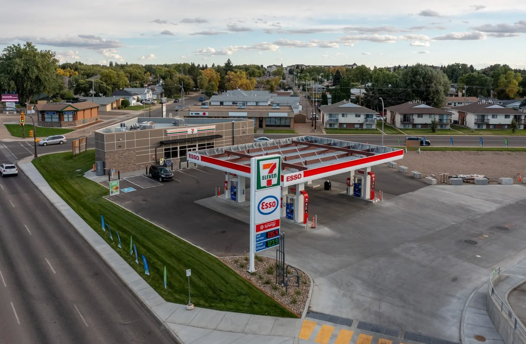 The main entrance of the NuHAA building, featuring a modern glass and stone facade, at sunset.