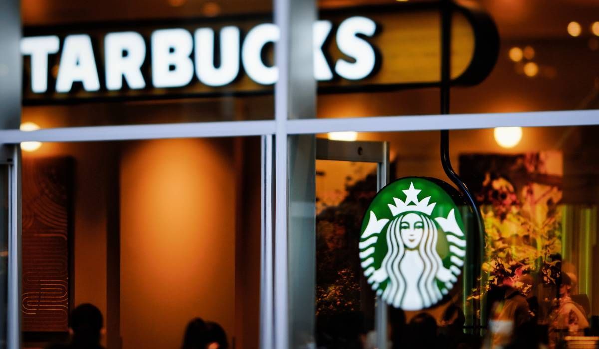 A starbucks store with a sign in the window