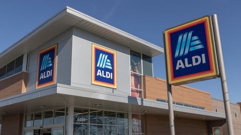 The front of an aldi store with a sign in front of it.