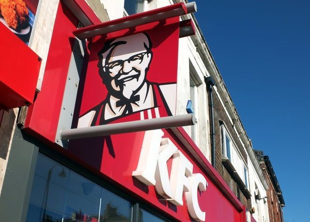A kfc restaurant with a sign that says ' mr. kentucky ' on it