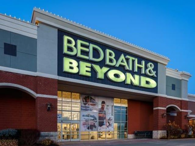 A bed bath and beyond store is lit up at night