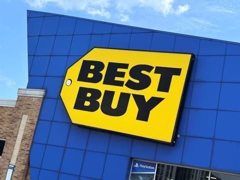 A blue building with a yellow sign that says best buy
