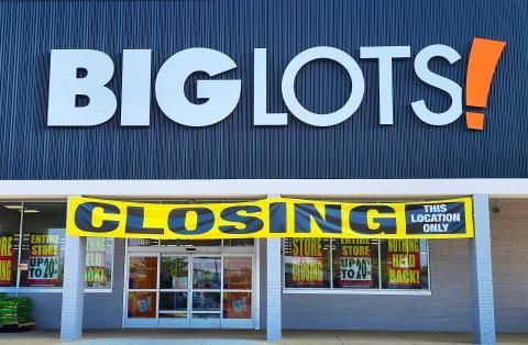 The front of a big lots store with a closing sign.