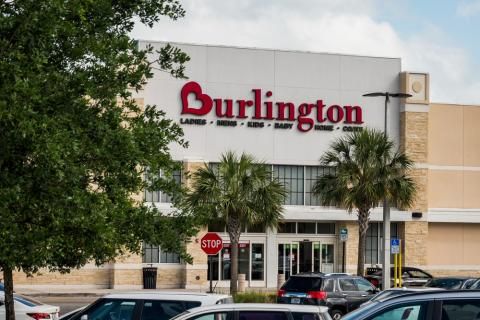 A burlington store with cars parked in front of it.