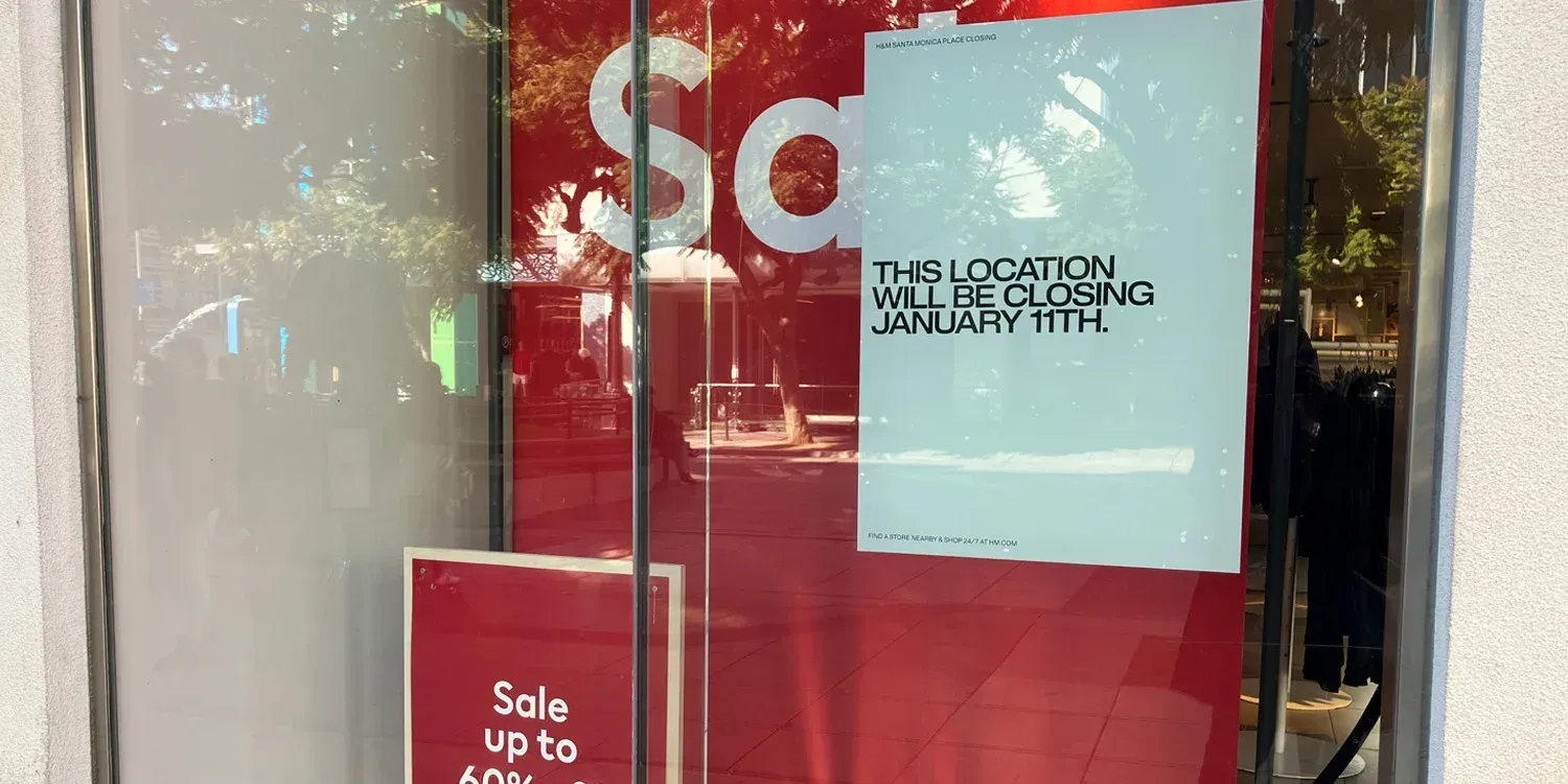 A store window with a sign that says `` sale up to 60 % ''.