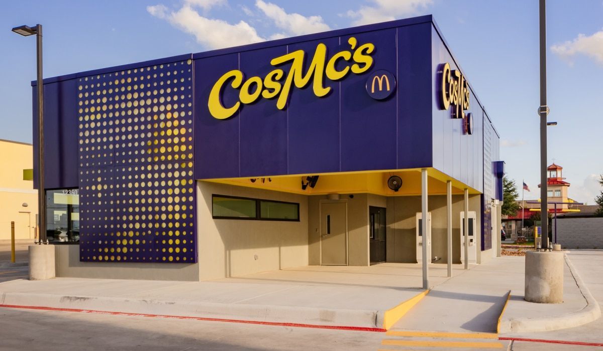 A purple and yellow building with the word cosmos on it