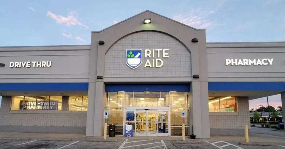 The front of a rite aid store with a sign on it.