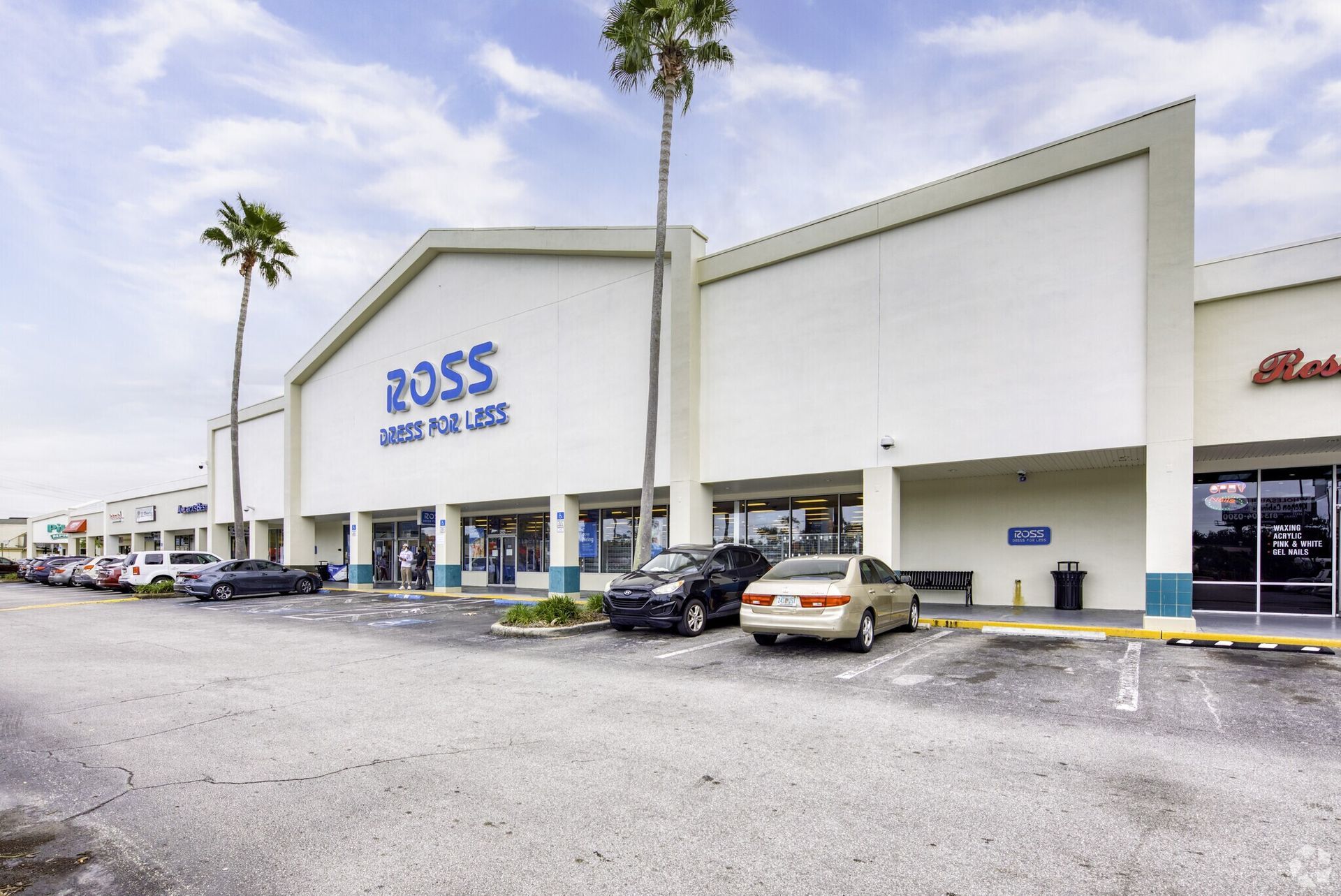 A ross store with cars parked in front of it