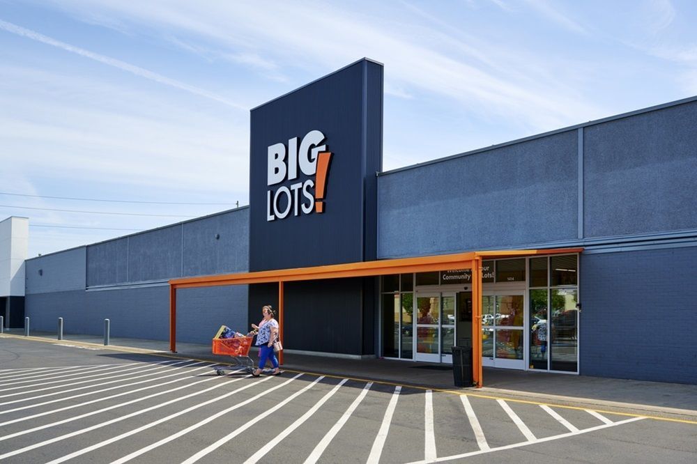 A big lots store with a parking lot in front of it