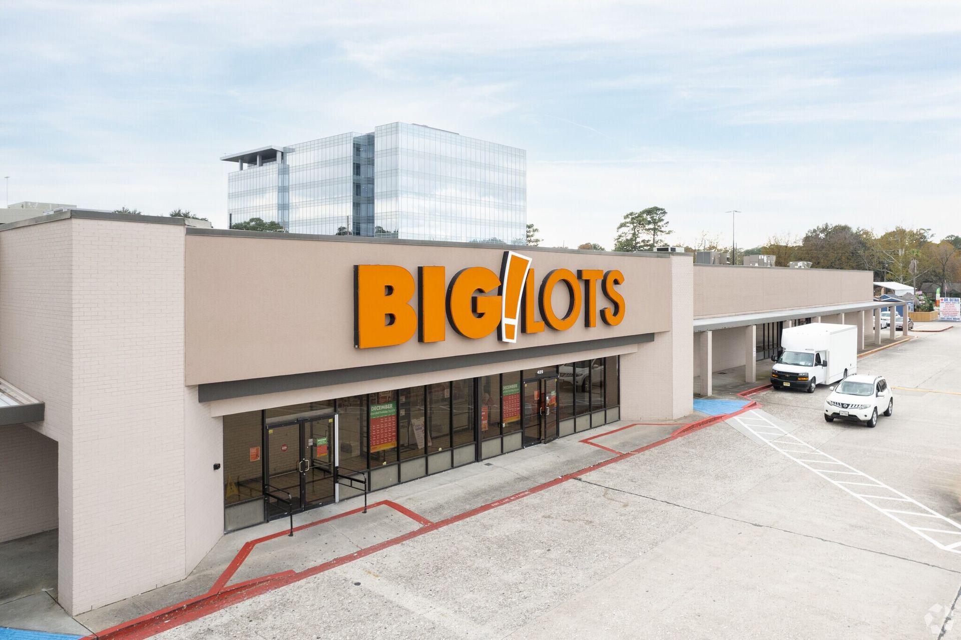 An aerial view of a big lots store with cars parked in front of it.