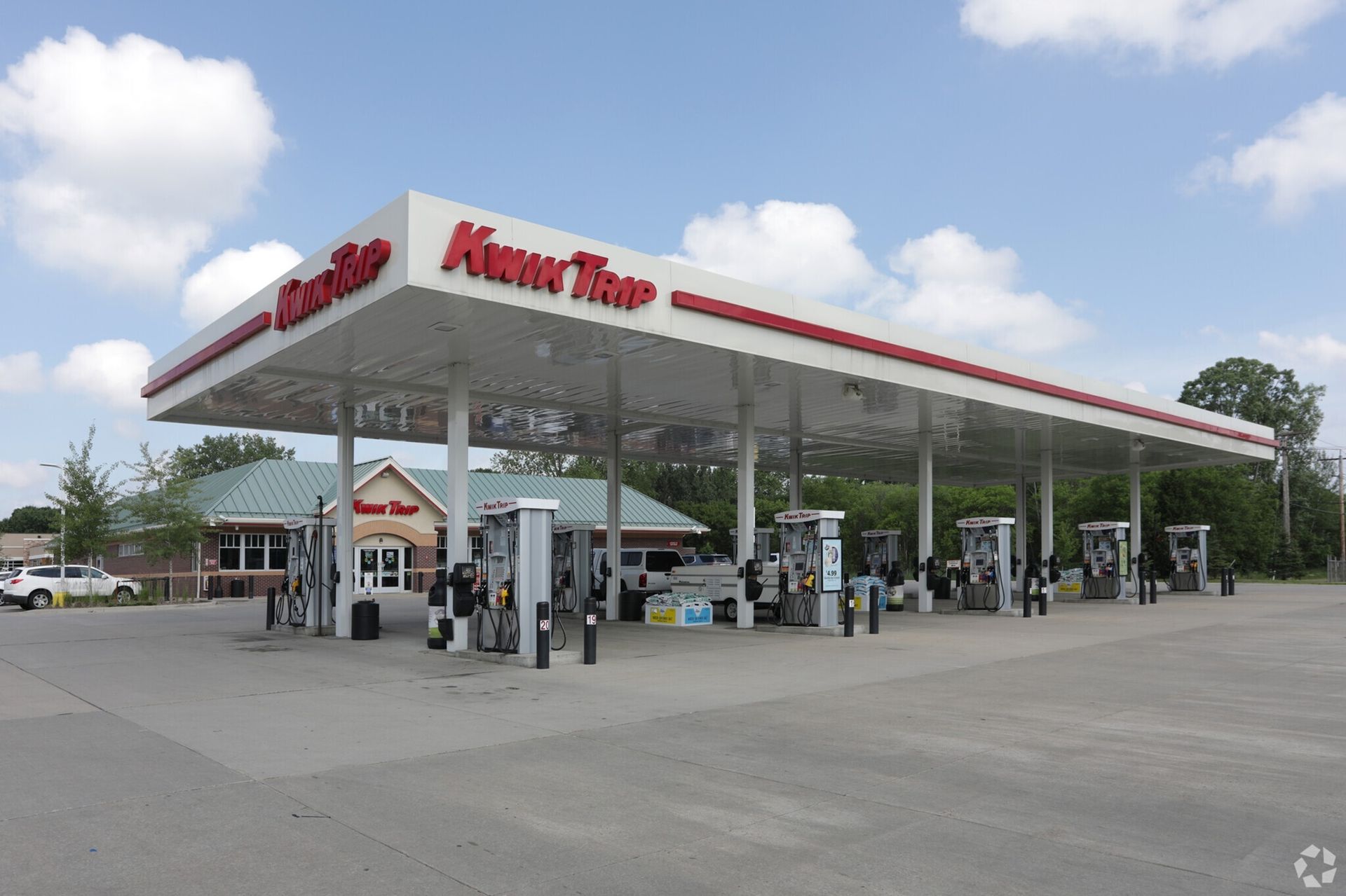 A gas station with a red and white sign that says meter time