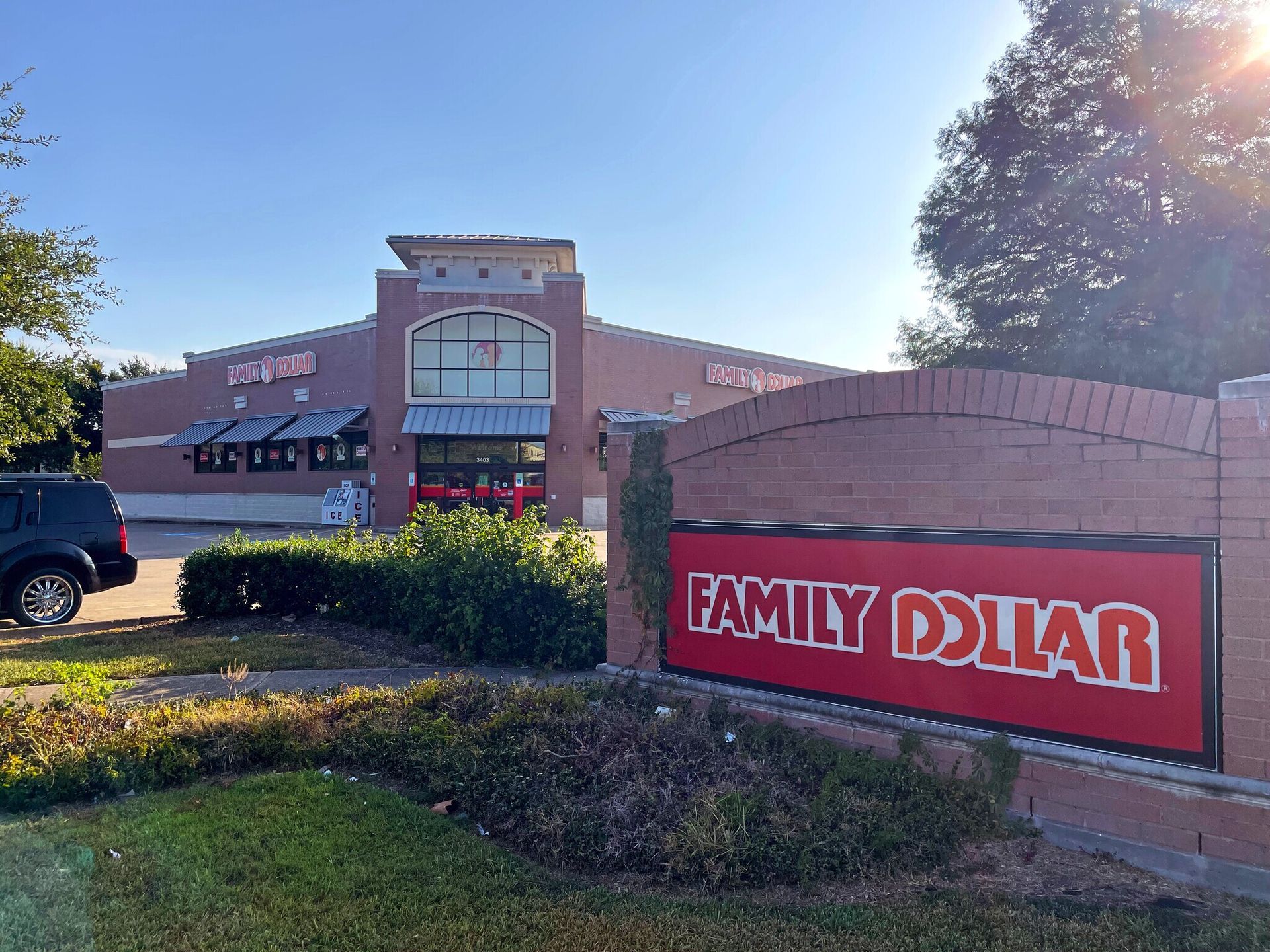 A family dollar store with a red sign in front of it.