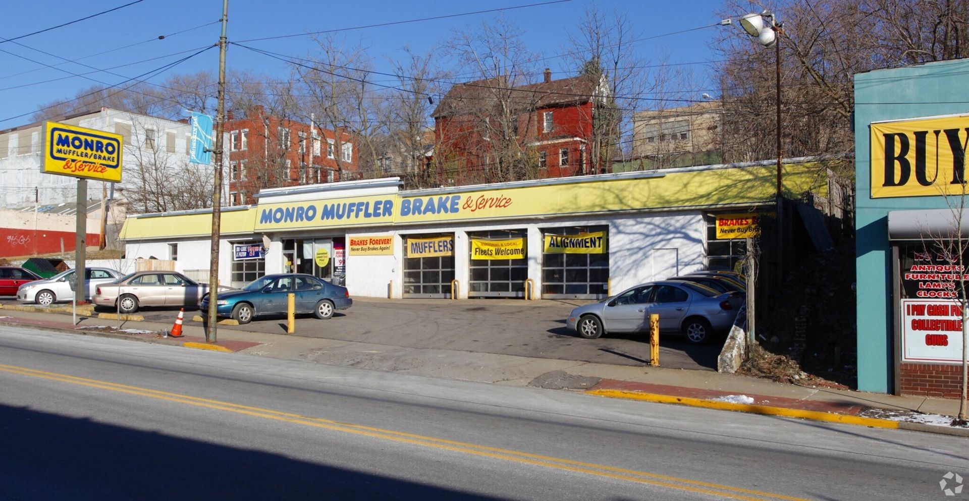 A car is parked in front of a sign that says 223