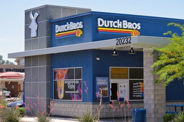A dutch bros restaurant with a blue building